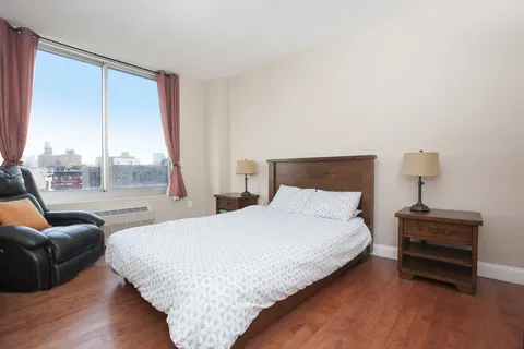 a bedroom with a bed and glass window
