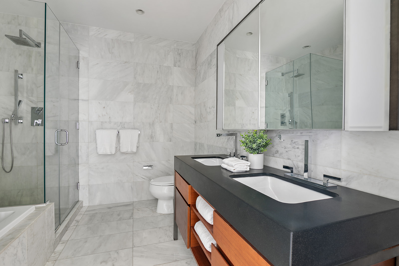 75 Wall Street, Unit 36F Manhattan, NY 10005 - Photo 7 of 15 a bathroom with a granite countertop sink a toilet and shower