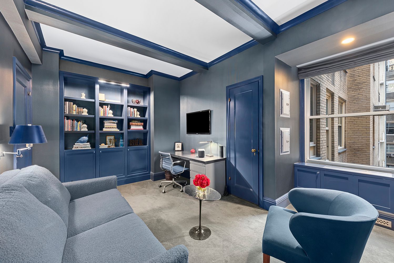 a living room with furniture and a flat screen tv