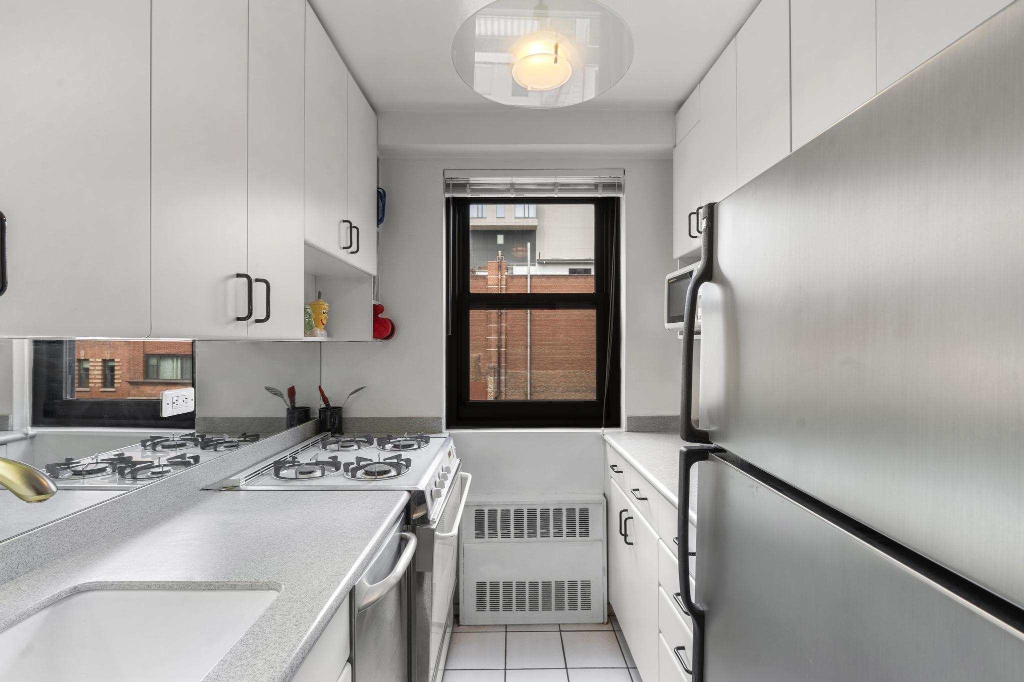 201 East 21st Street, Unit 8E Manhattan, NY 10010 - Photo 5 of 9 a bathroom with a sink and a mirror