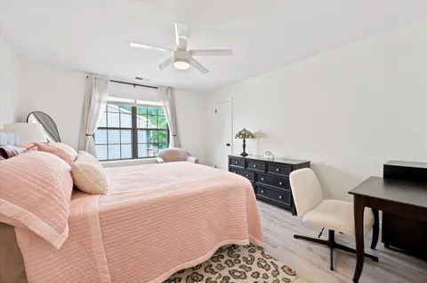 a bedroom with a bed a table and chair
