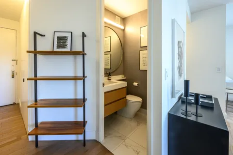 a bathroom with a toilet a sink and mirror