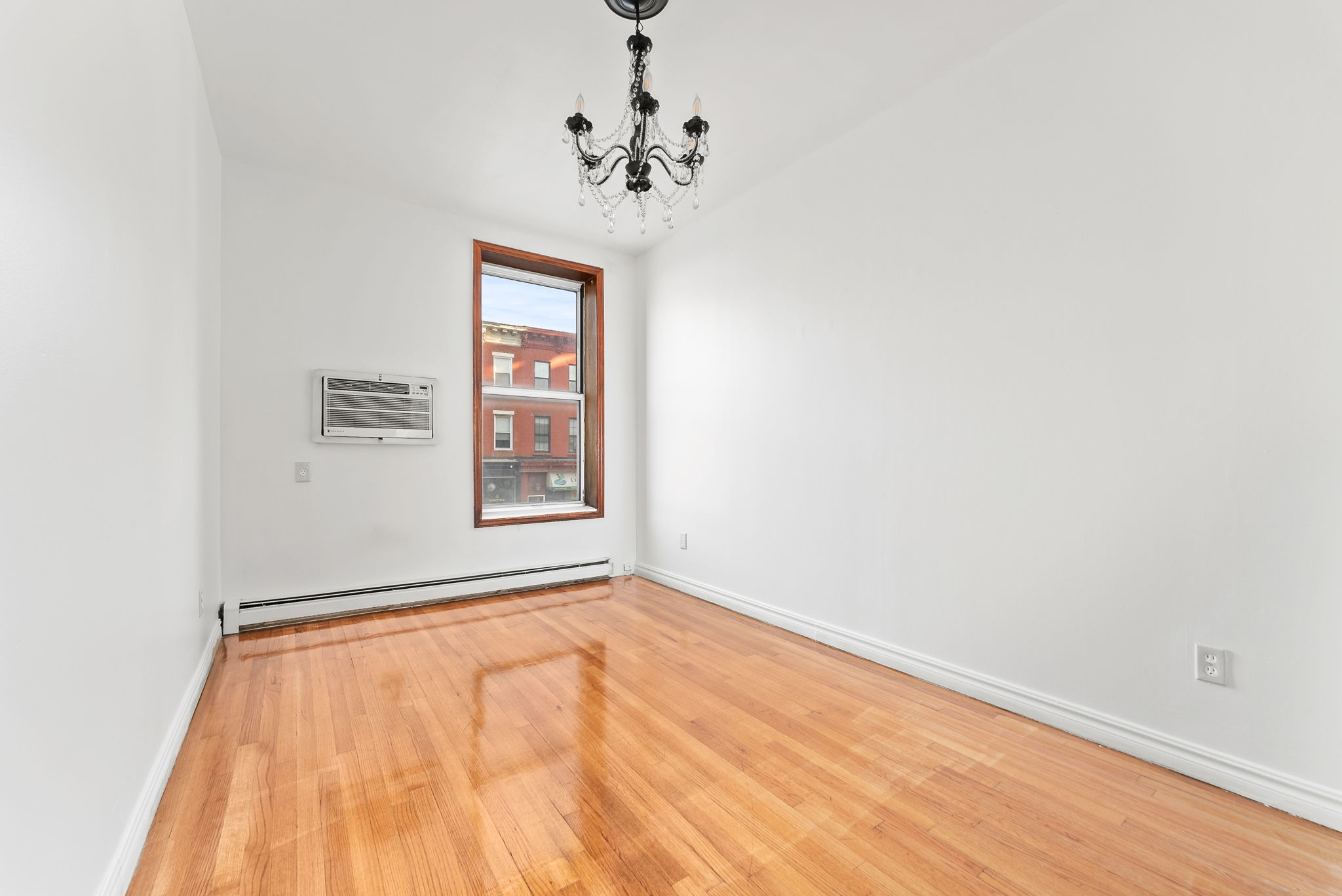 462 3rd Avenue, Unit 2 Brooklyn, NY 11215 - Photo 4 of 8 a view of an empty room with a window