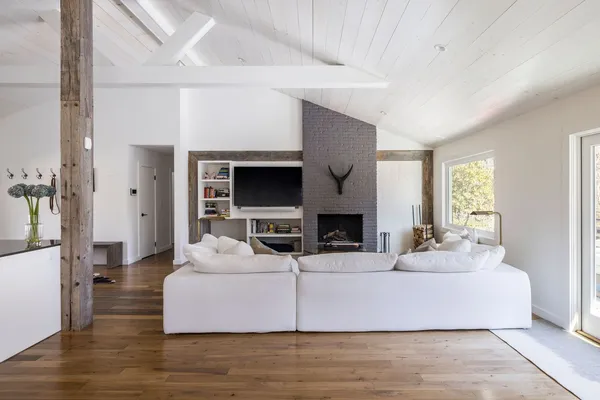 a living room with fireplace furniture and a flat screen tv