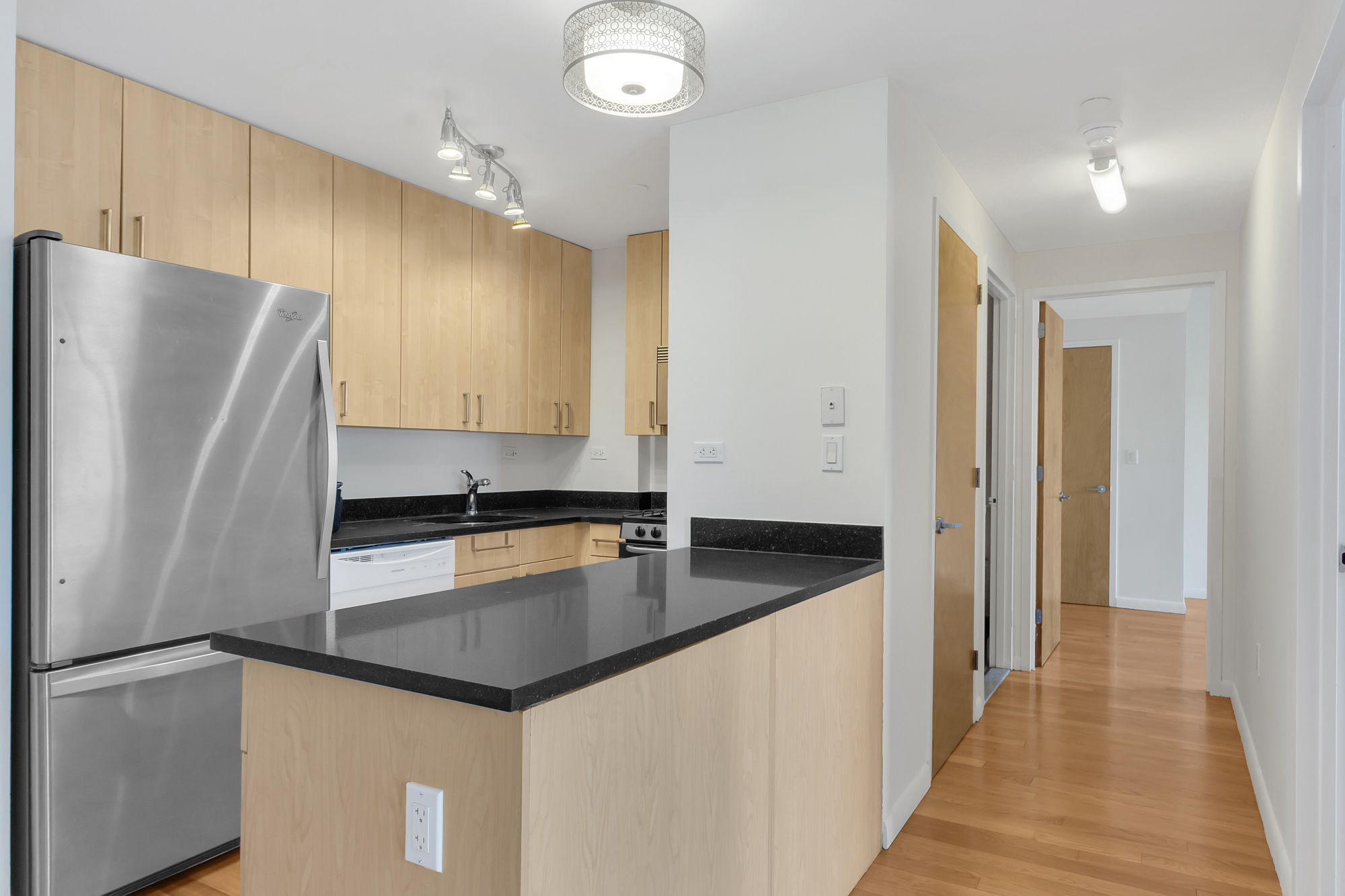 736 West 187th Street, Unit 502 Manhattan, NY 10033 - Photo 3 of 11 a kitchen with granite countertop a refrigerator and a sink
