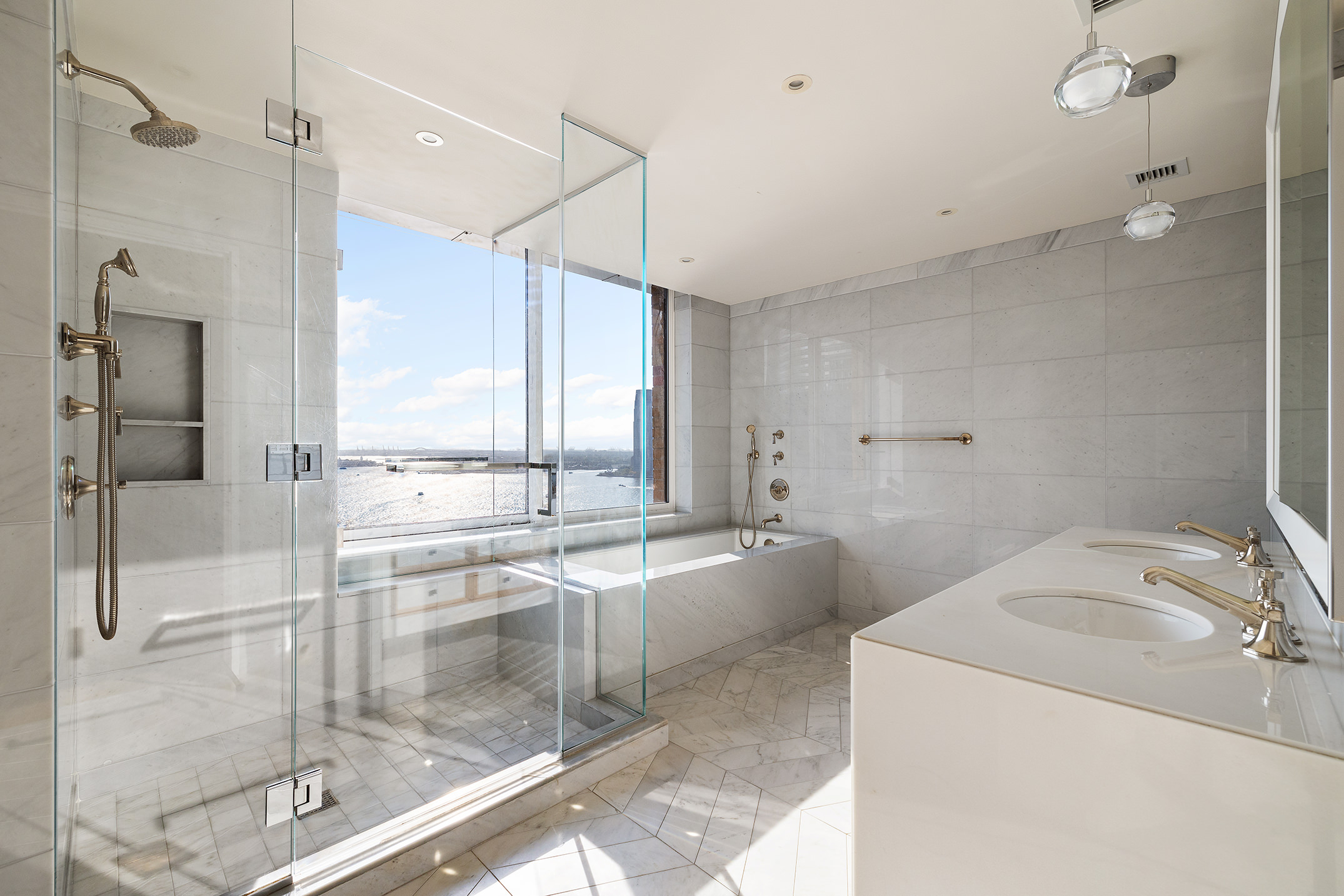 212 Warren Street, Unit PHS Manhattan, NY 10282 - Photo 11 of 18 a bathroom with a tub sink and mirror