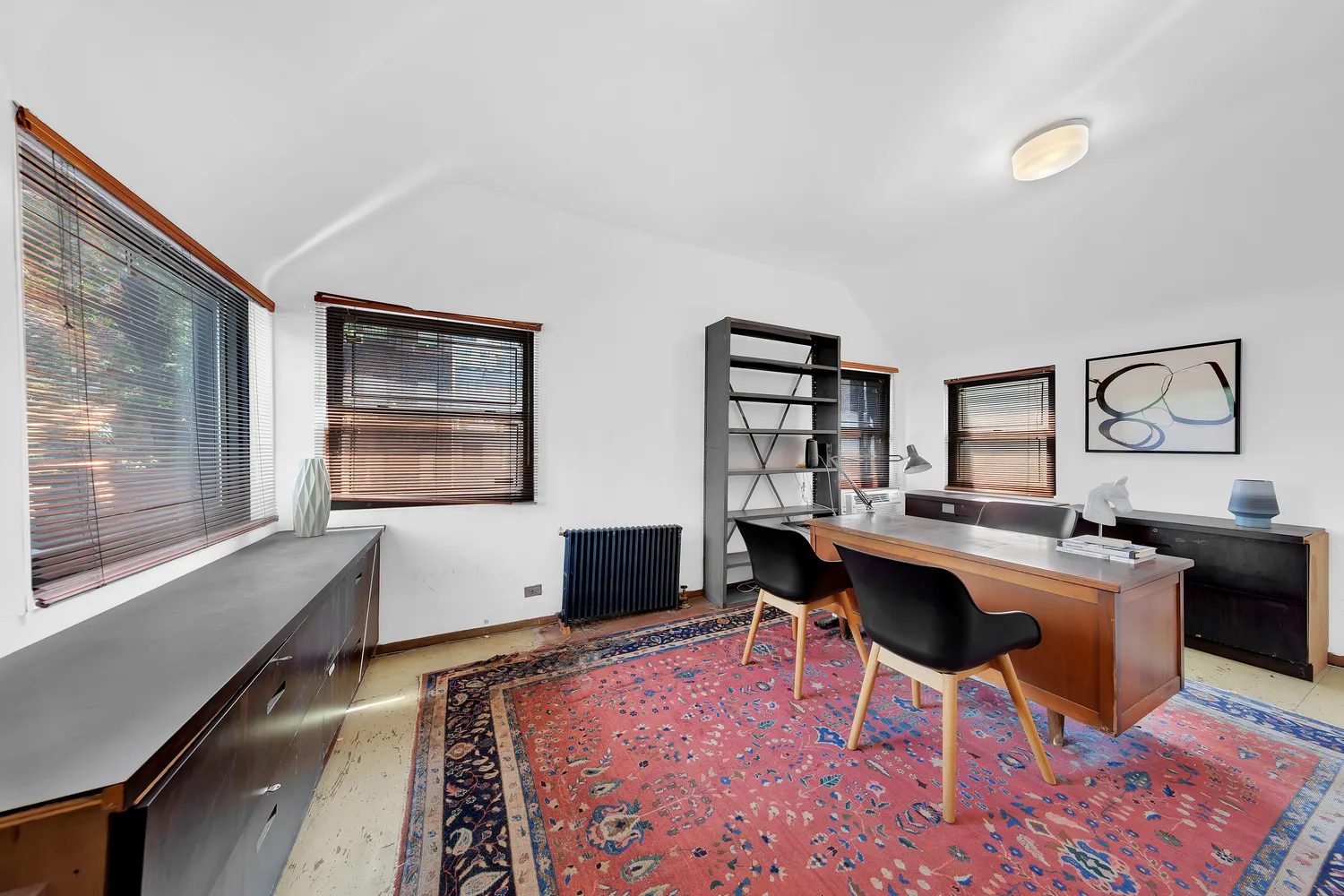 a view of a workspace with furniture and a window