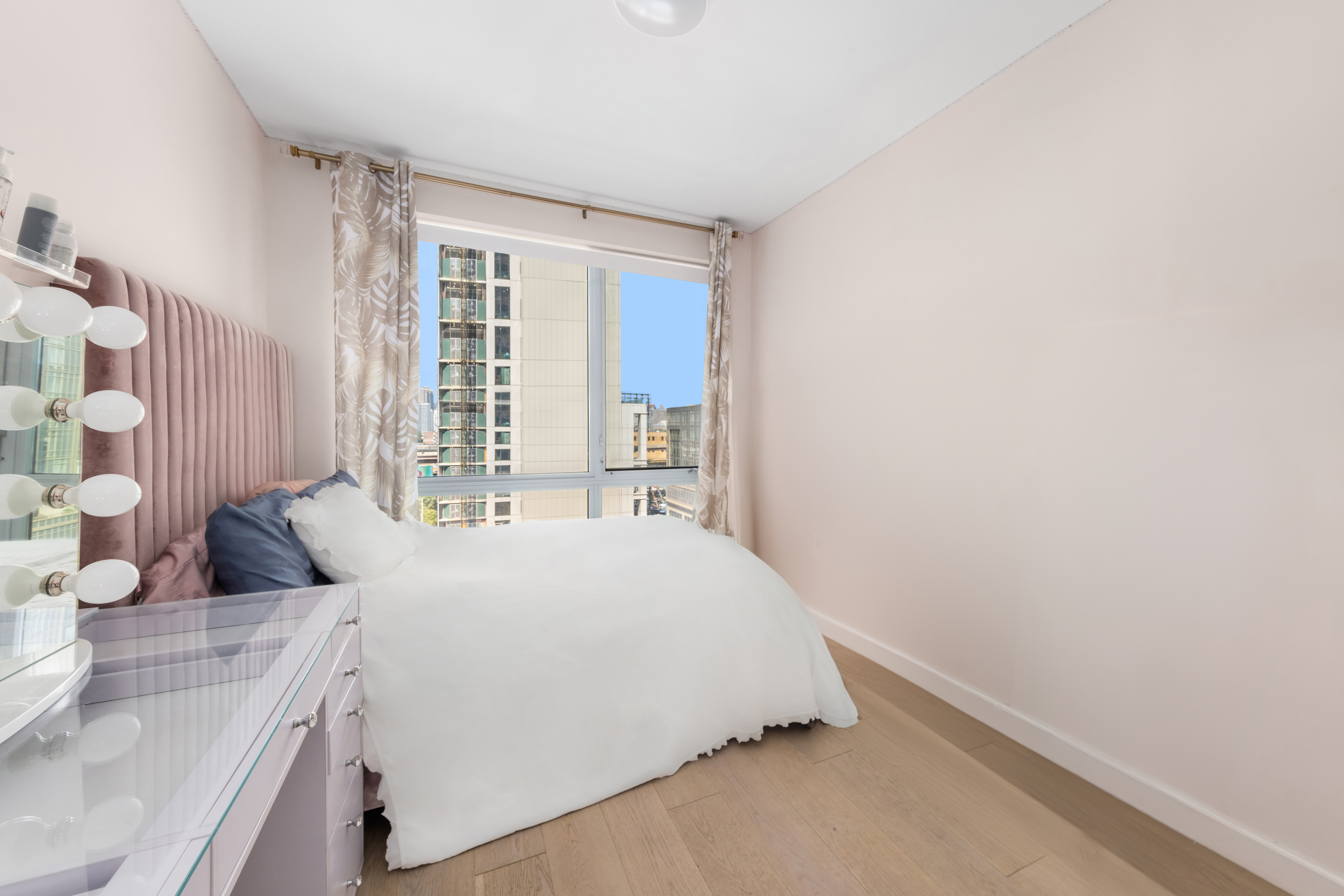 42-44 Crescent Street, Unit PHB Queens, NY 11101 - Photo 6 of 11 a bedroom with a bed and a large window
