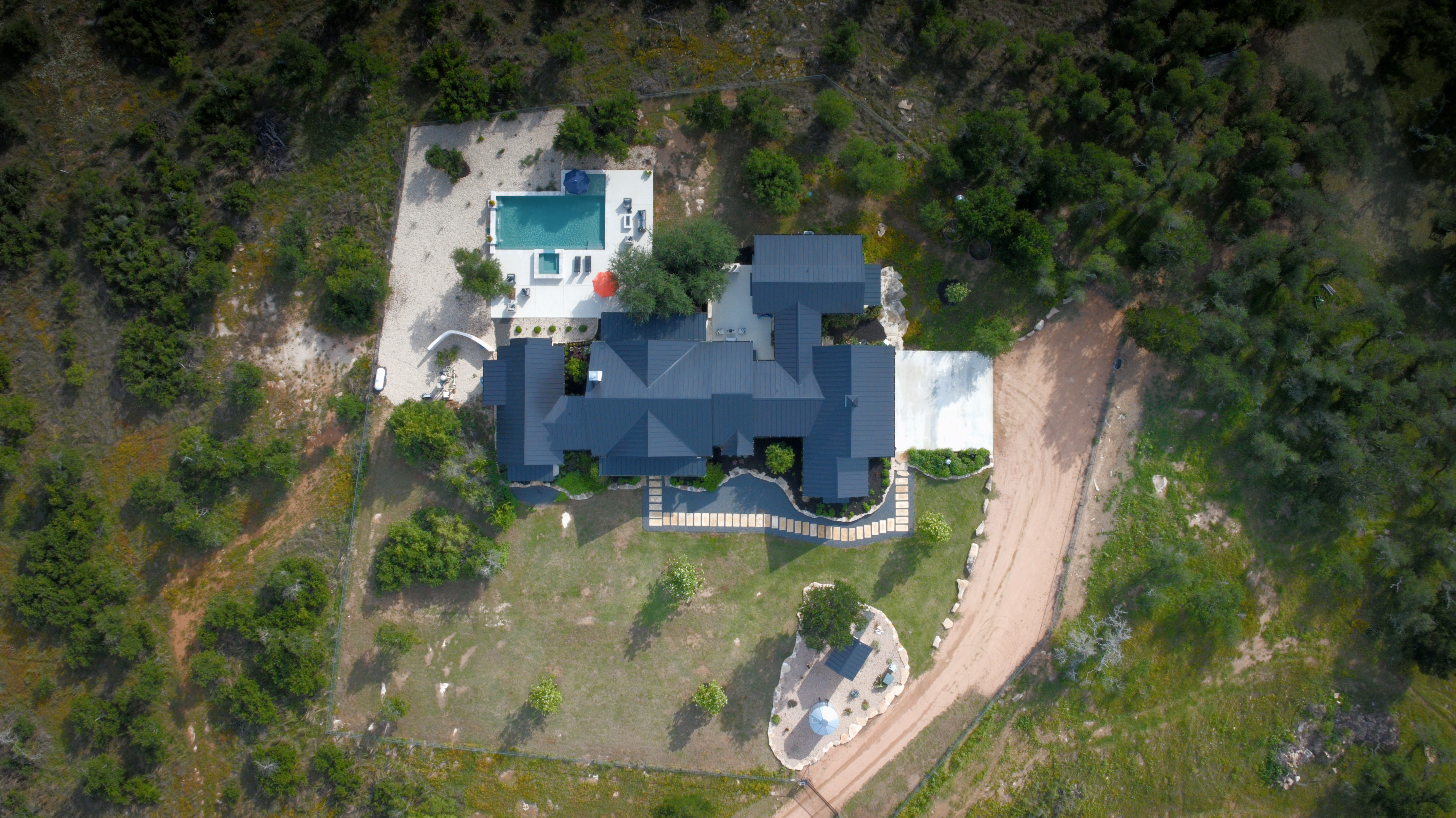 272 Slate Rock Road Willow City, TX 78675 - Photo 25 of 30 an aerial view of a house with yard swimming pool and outdoor seating