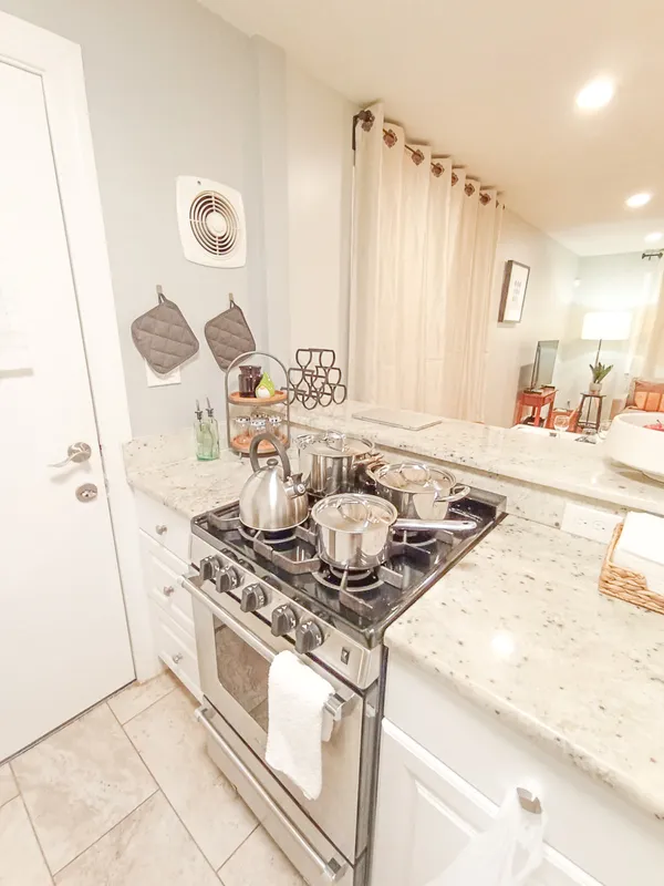 a stove top oven sitting inside of a kitchen