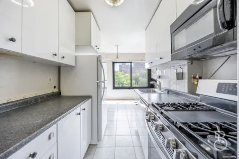 a kitchen with stainless steel appliances granite countertop a stove and a refrigerator