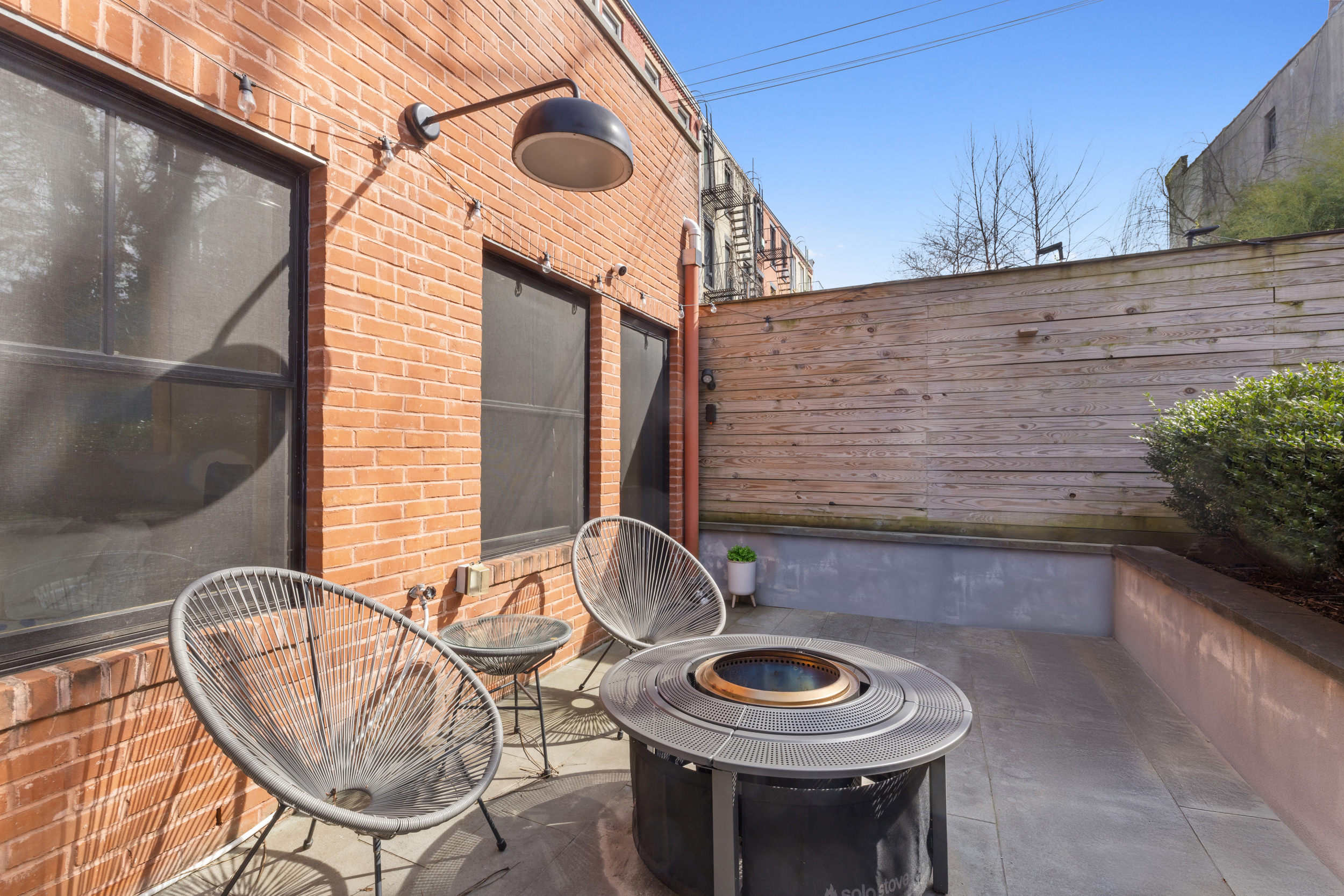 252 Stuyvesant Avenue Brooklyn, NY 11221 - Photo 14 of 26 a view of a chair and fire pit in the patio