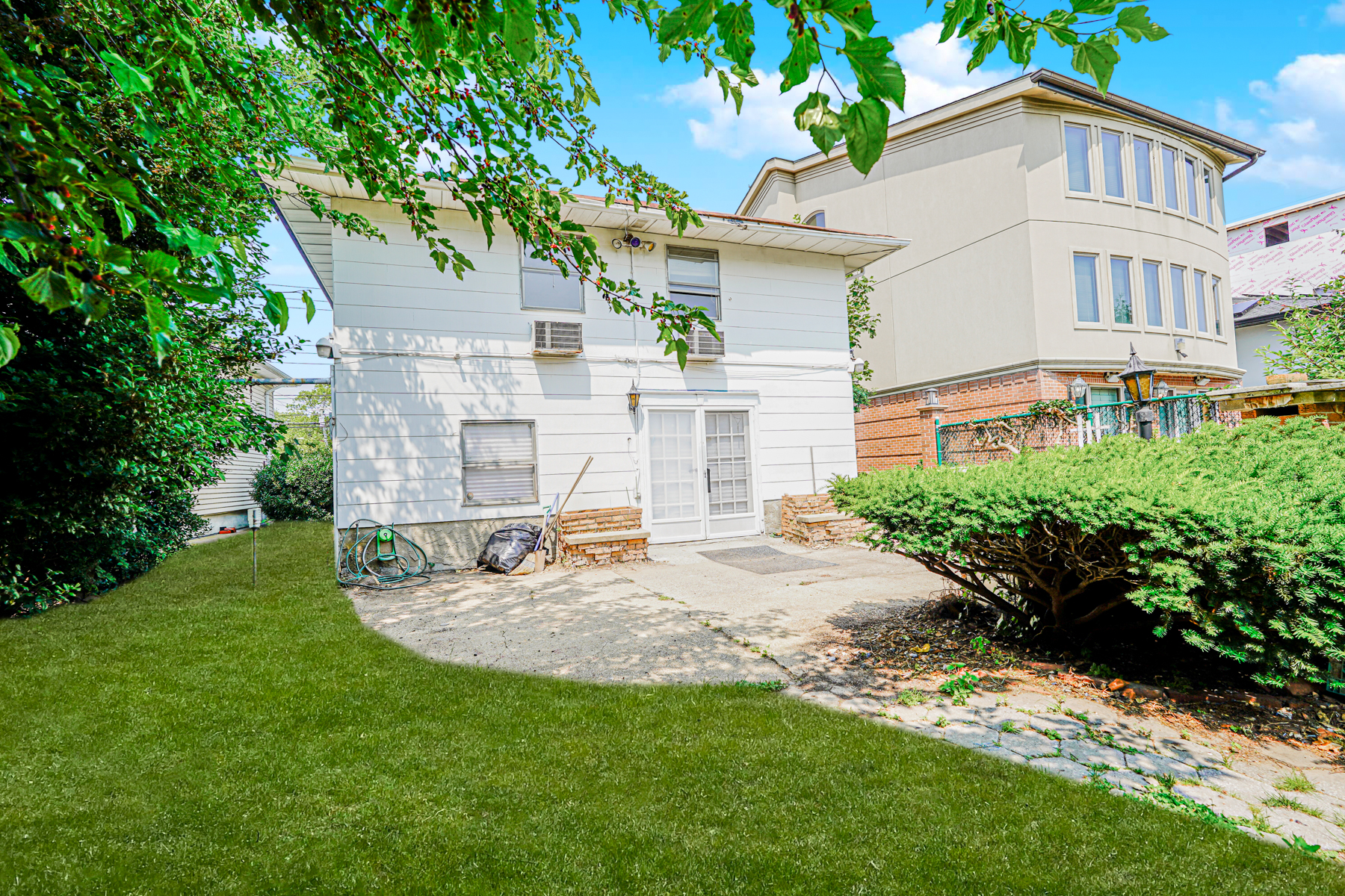461 Mayfair Drive South Brooklyn, NY 11234 - Photo 2 of 30 a view of a white house with a yard and sitting area