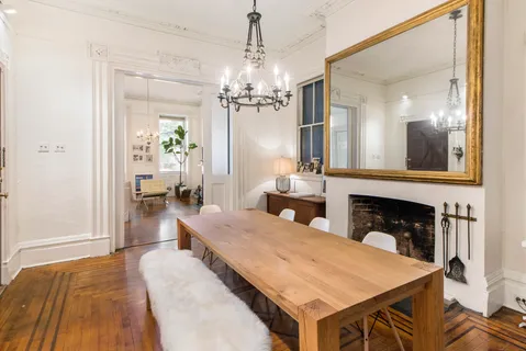 a living room with furniture a fireplace and a chandelier