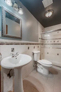 a bathroom with a sink toilet and a mirror