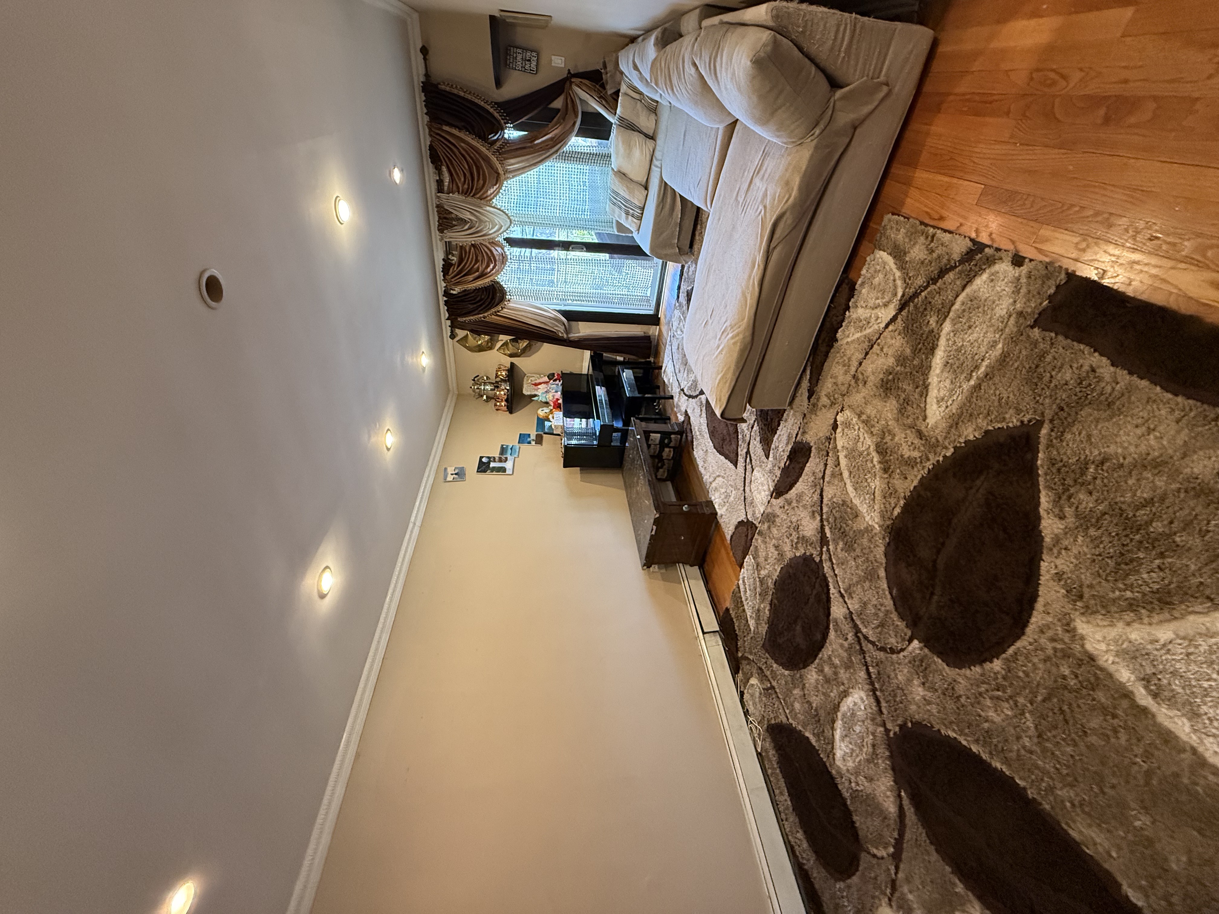 62-23 69th Place Queens, NY 11379 - Photo 3 of 4 a room with a bed and a couch