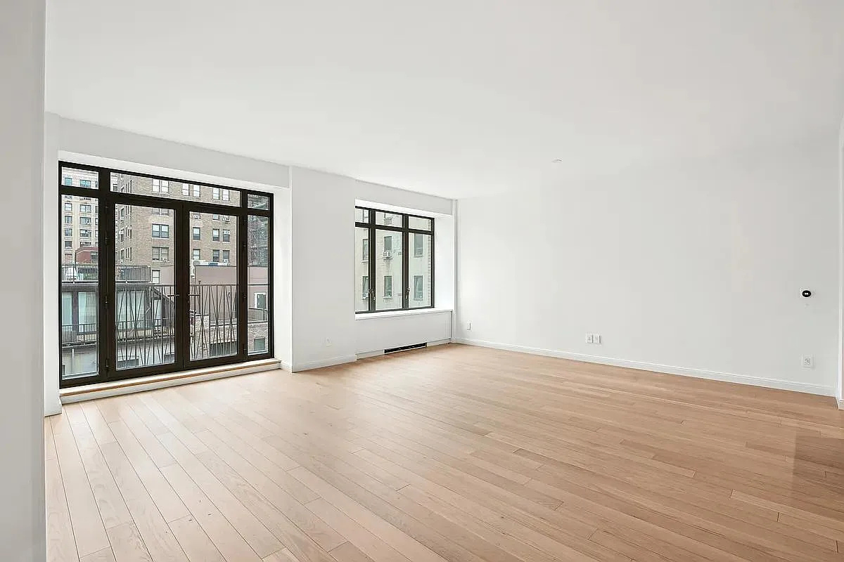 269 West 87th Street, Unit 9B Manhattan, NY 10024 - Photo 1 of 23 an empty room with wooden floor and windows
