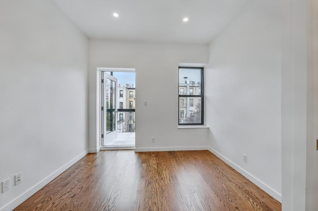 109 President Street, Unit 4 Brooklyn, NY 11231 - Photo 12 of 22 an empty room with wooden floor and windows