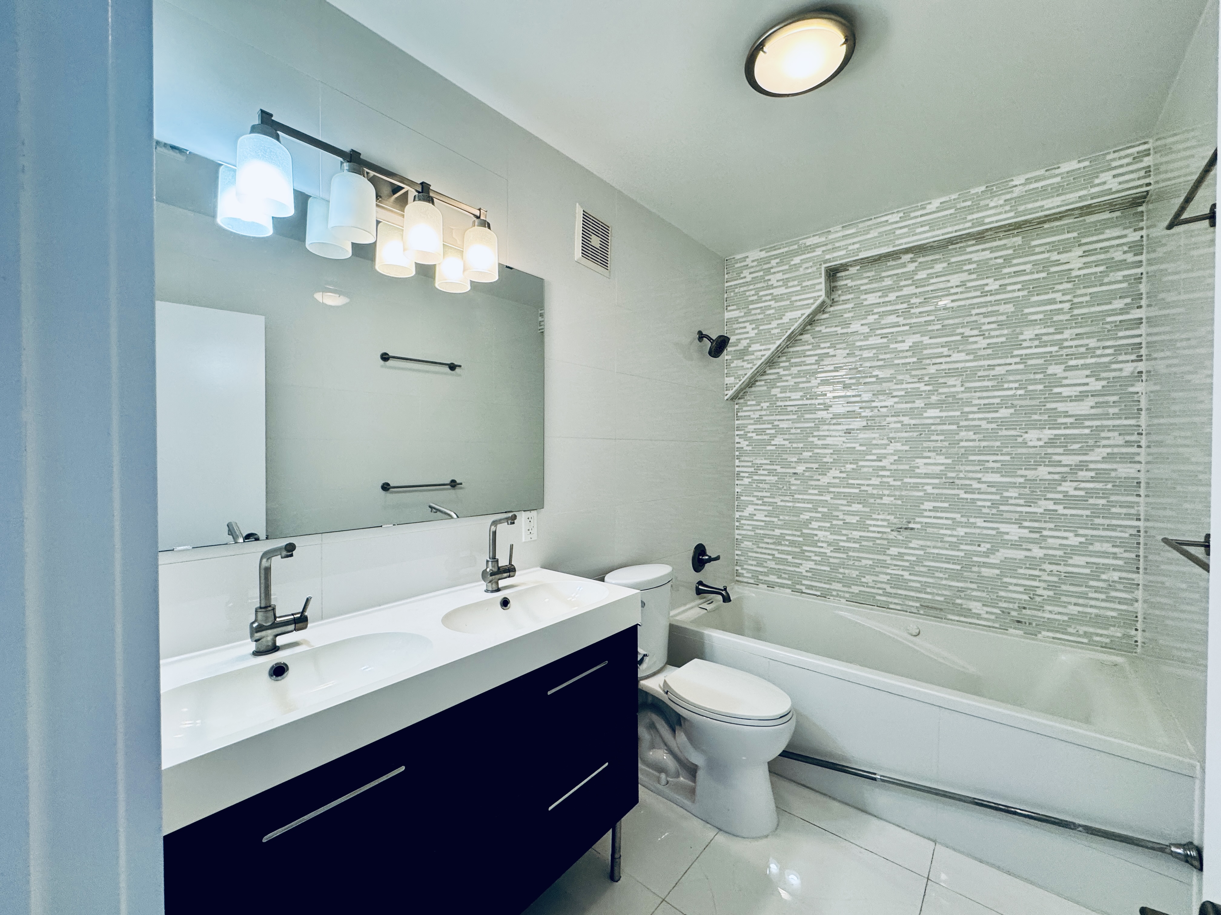 29 MacDougal Street, Unit 2 Brooklyn, NY 11233 - Photo 11 of 14 a bathroom with a double vanity sink mirror and toilet