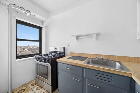 a kitchen that has a sink and a stove