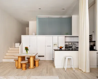 a dining room with furniture and wooden floor