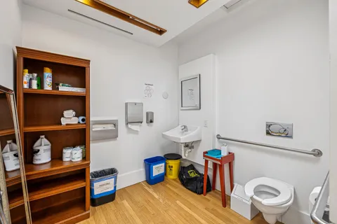 a bathroom with a toilet and a shower