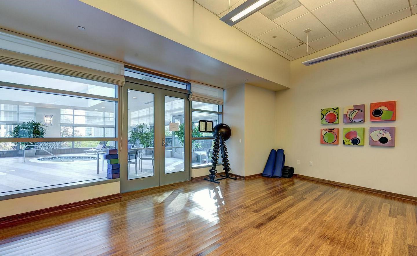 1881 North Nash Street, Unit 1009 Arlington, VA 22209 - Photo 22 of 36 a view of a room with gym equipment and floor to ceiling window