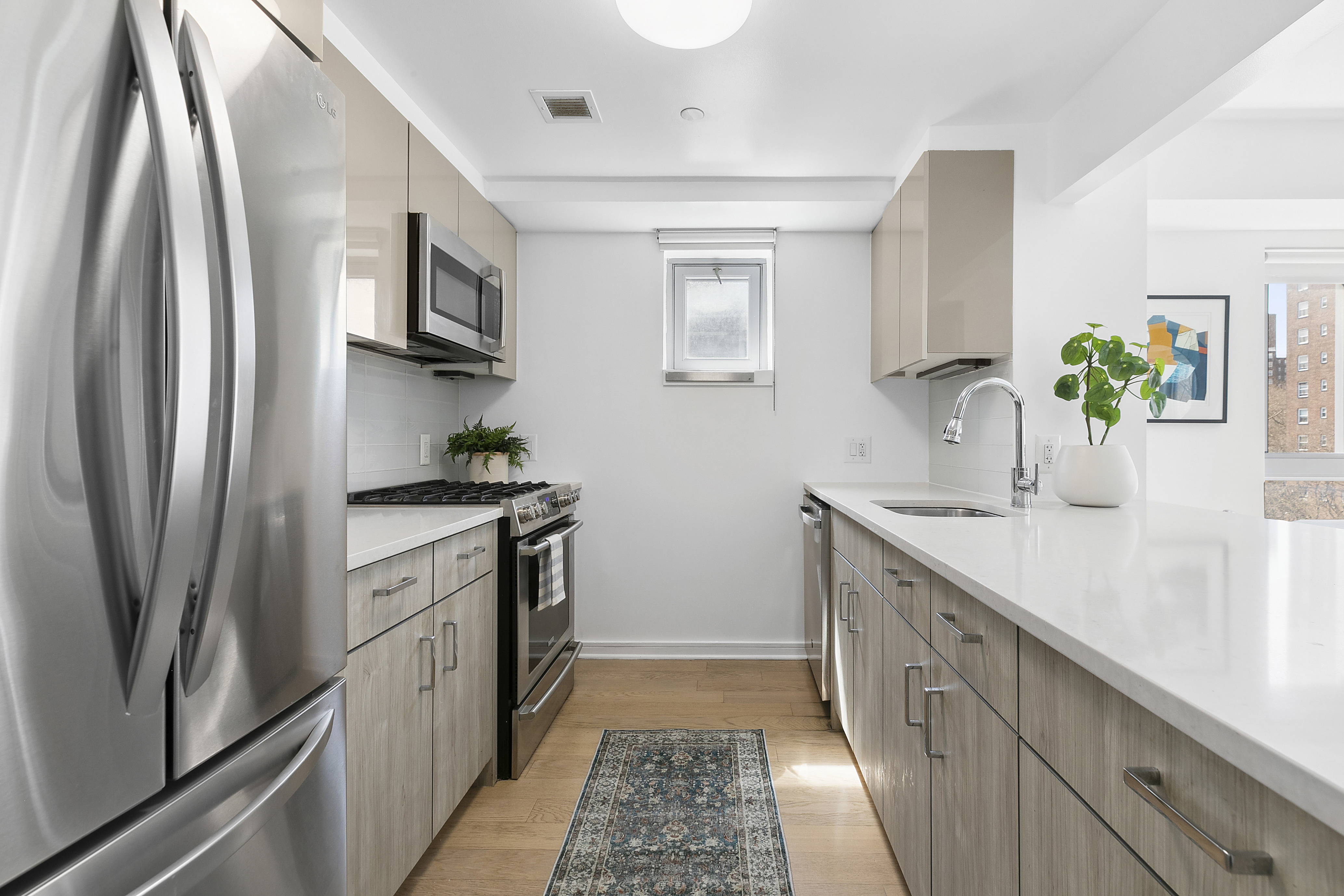 171 West 131st Street, Unit 407 Manhattan, NY 10027 - Photo 4 of 18 a kitchen with stainless steel appliances a sink stove and refrigerator