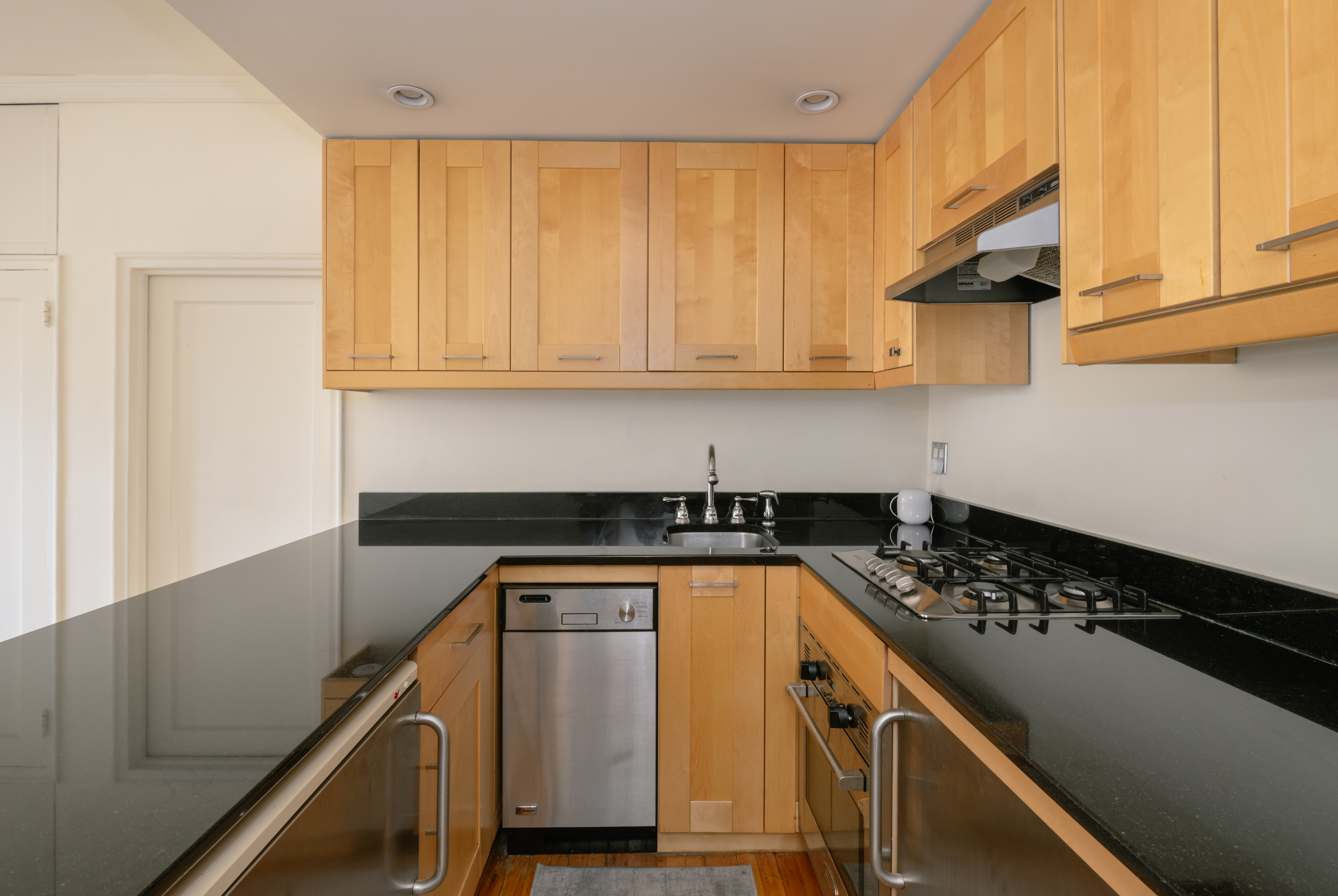 25 Minetta Lane, Unit 6G Manhattan, NY 10012 - Photo 3 of 13 a kitchen with a sink a stove and cabinets