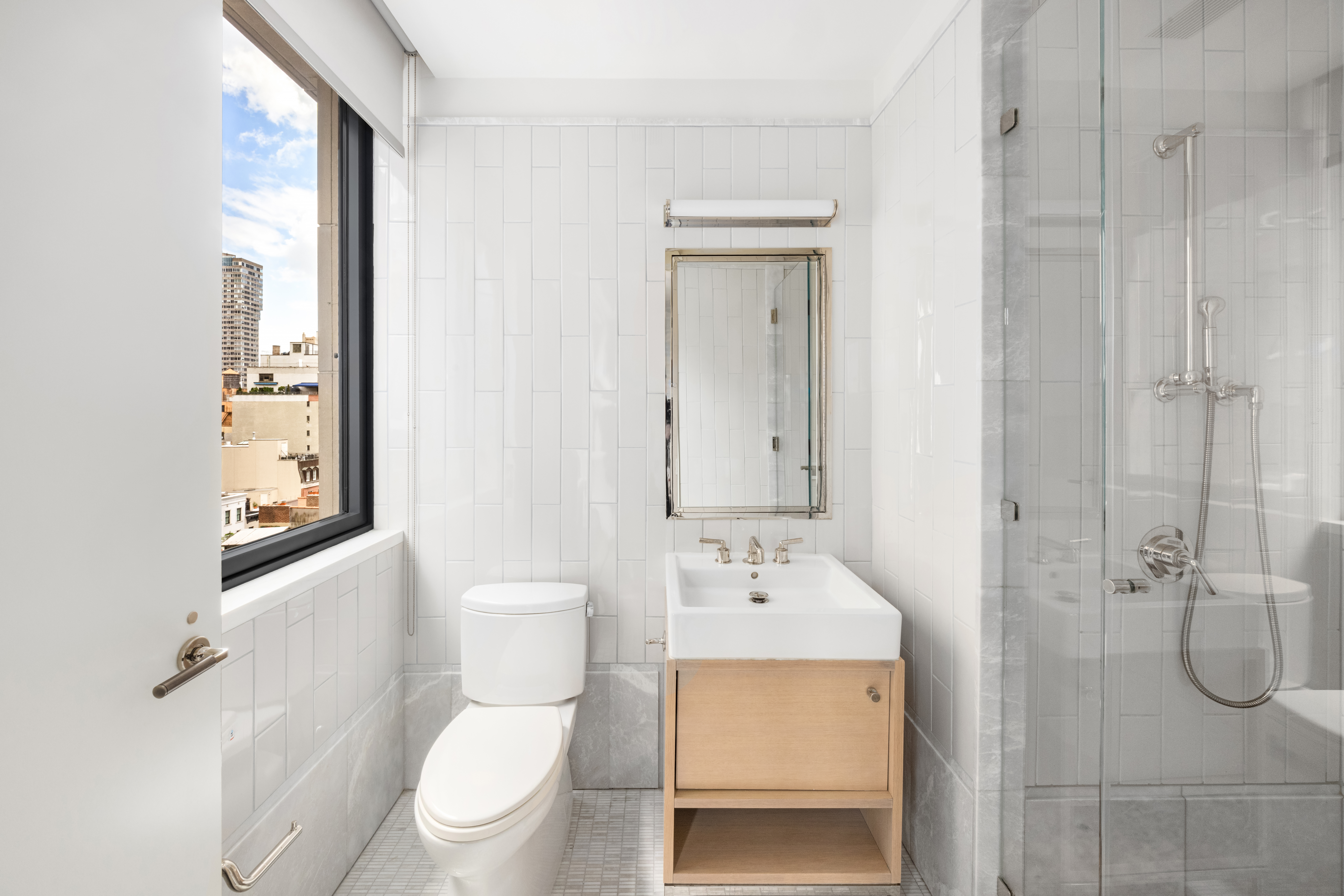 301 East 50th Street, Unit 8C Manhattan, NY 10022 - Photo 10 of 20 a bathroom with a toilet a sink and shower