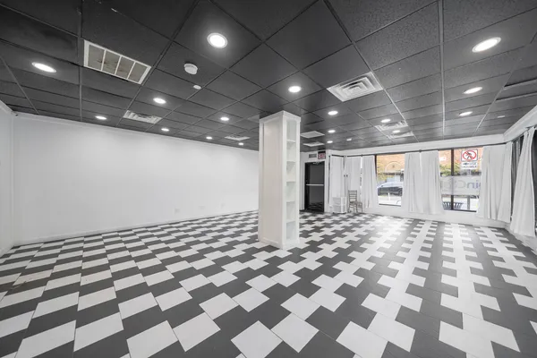 a view of a big room with a fireplace and a projector