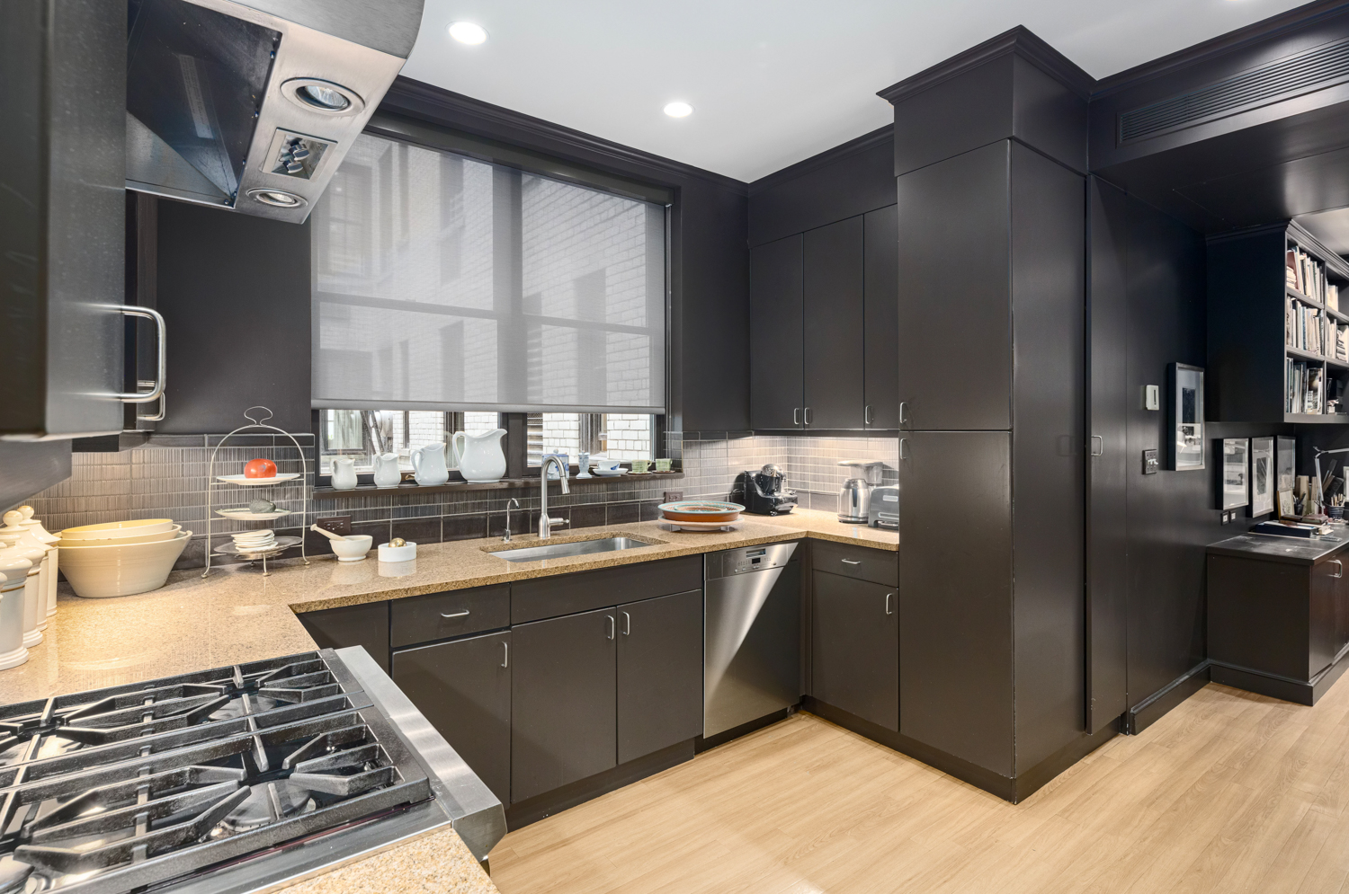 570 Park Avenue, Unit 4A Manhattan, NY 10065 - Photo 8 of 20 a kitchen with stainless steel appliances granite countertop a sink stove and refrigerator