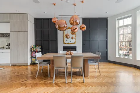 a view of a dining room with furniture window and wooden floor