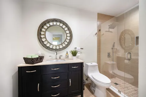 a bathroom with a toilet a sink and a mirror