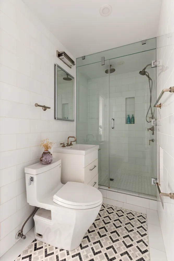 a white toilet sitting next to a bathroom sink