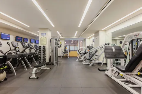 a living room with furniture windows and a wooden floor