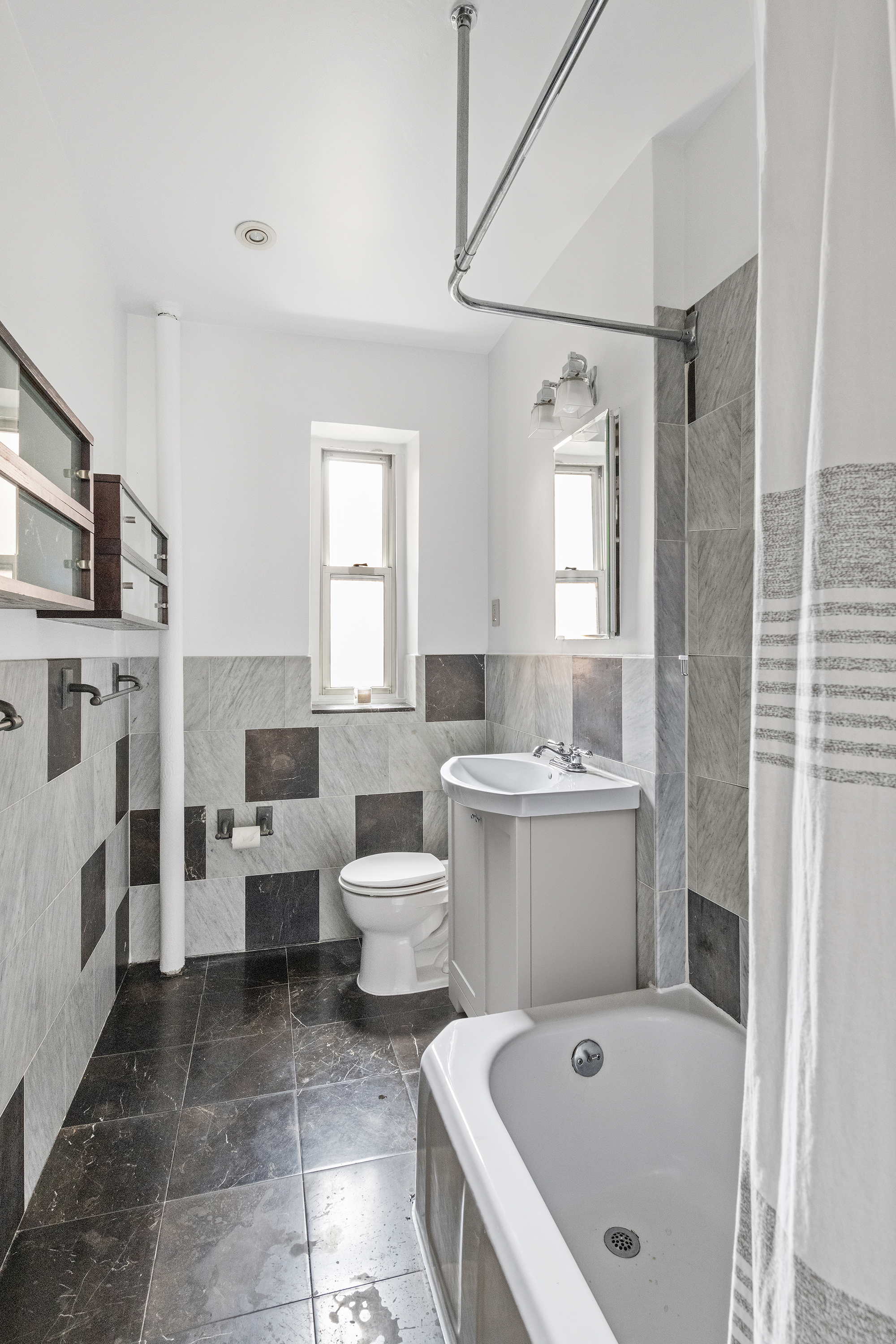 525 East 89th Street, Unit 3A Manhattan, NY 10128 - Photo 7 of 11 a bathroom with a tub sink and mirror