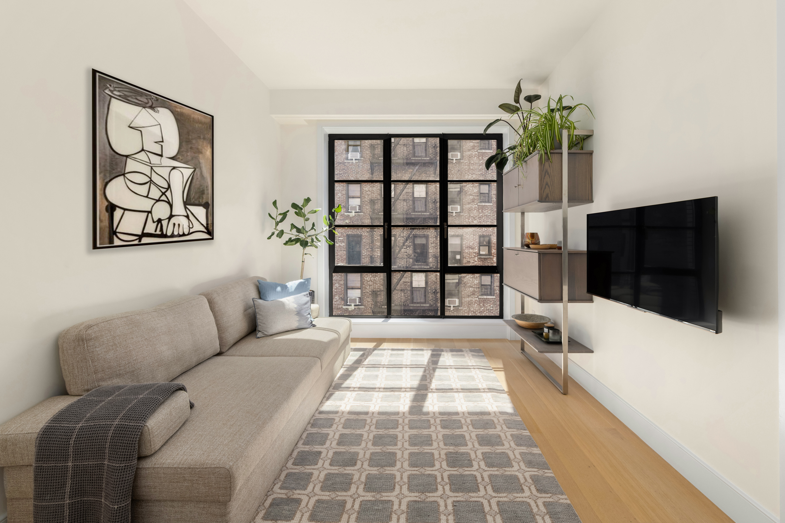 134 West 83rd Street, Unit 4 Manhattan, NY 10024 - Photo 15 of 17 a living room with furniture and a flat screen tv