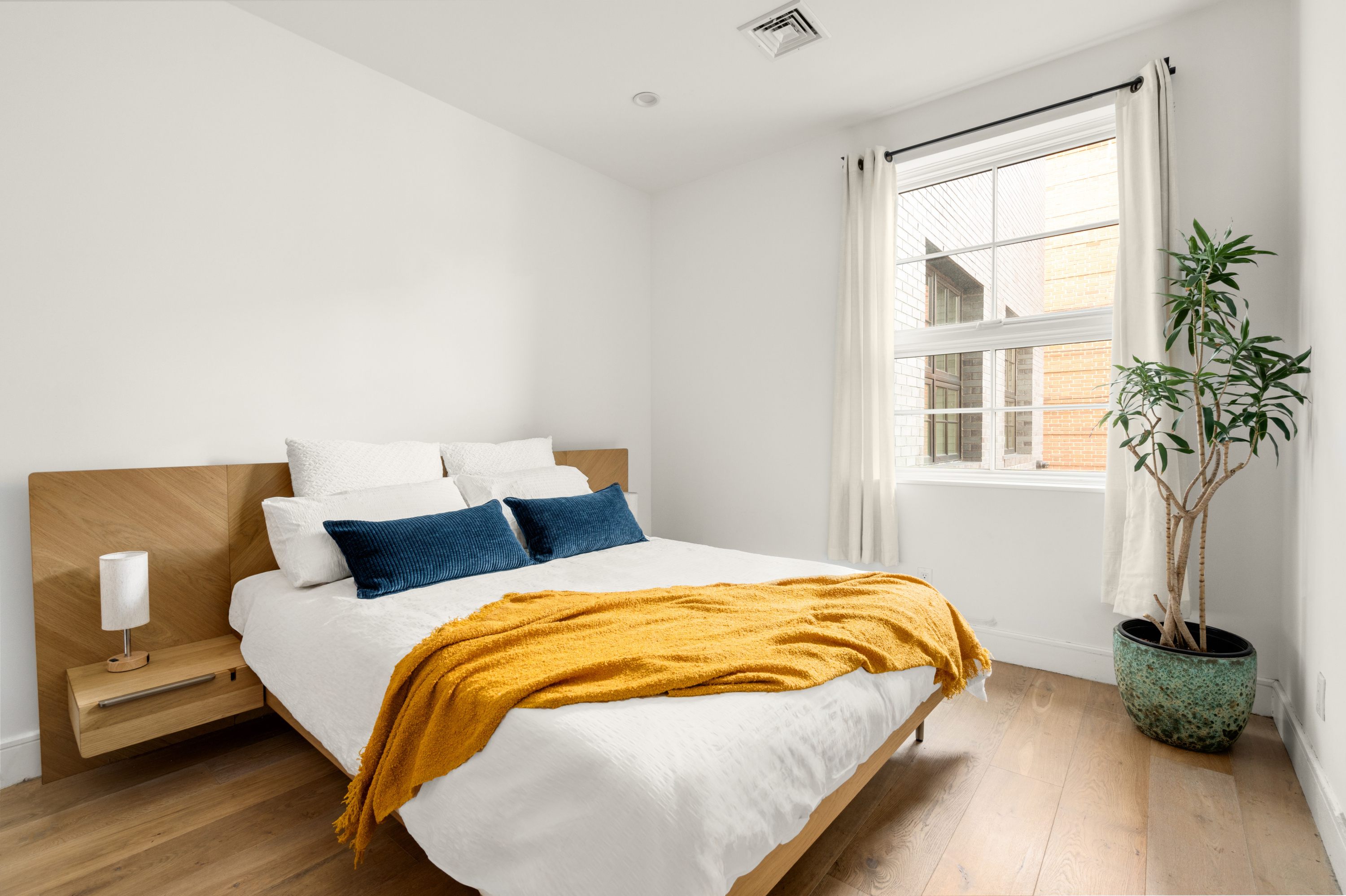 40 Huntington Street, Unit 2C Brooklyn, NY 11231 - Photo 5 of 9 a bedroom with a bed and a potted plant