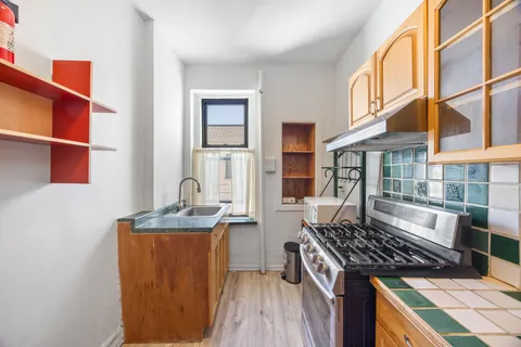 a kitchen with stainless steel appliances granite countertop a stove and a sink