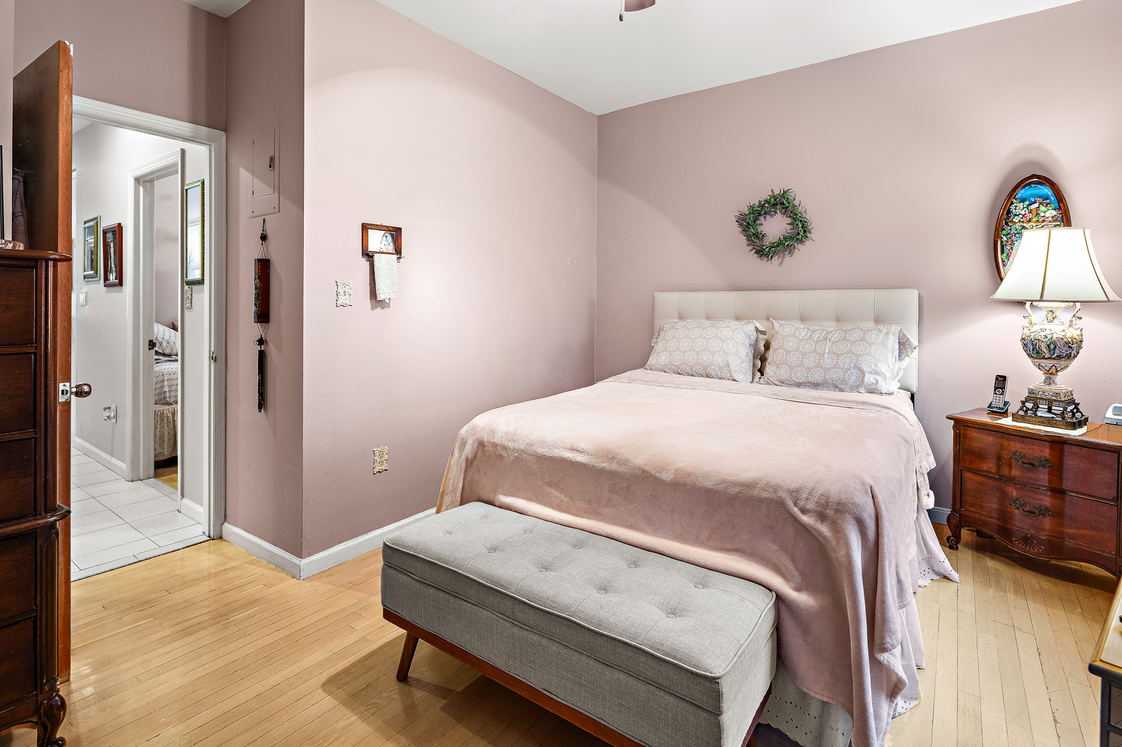 558 84th Street Brooklyn, NY 11209 - Photo 12 of 25 a bedroom with a bed and a lamp on table