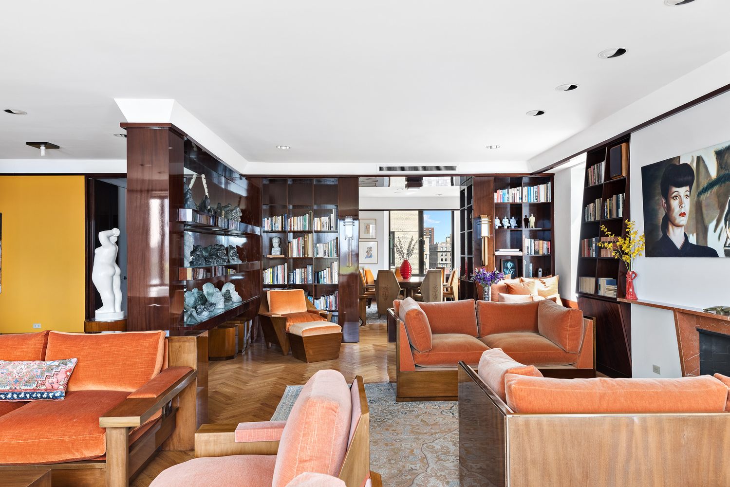 a living room with furniture kitchen view and large windows