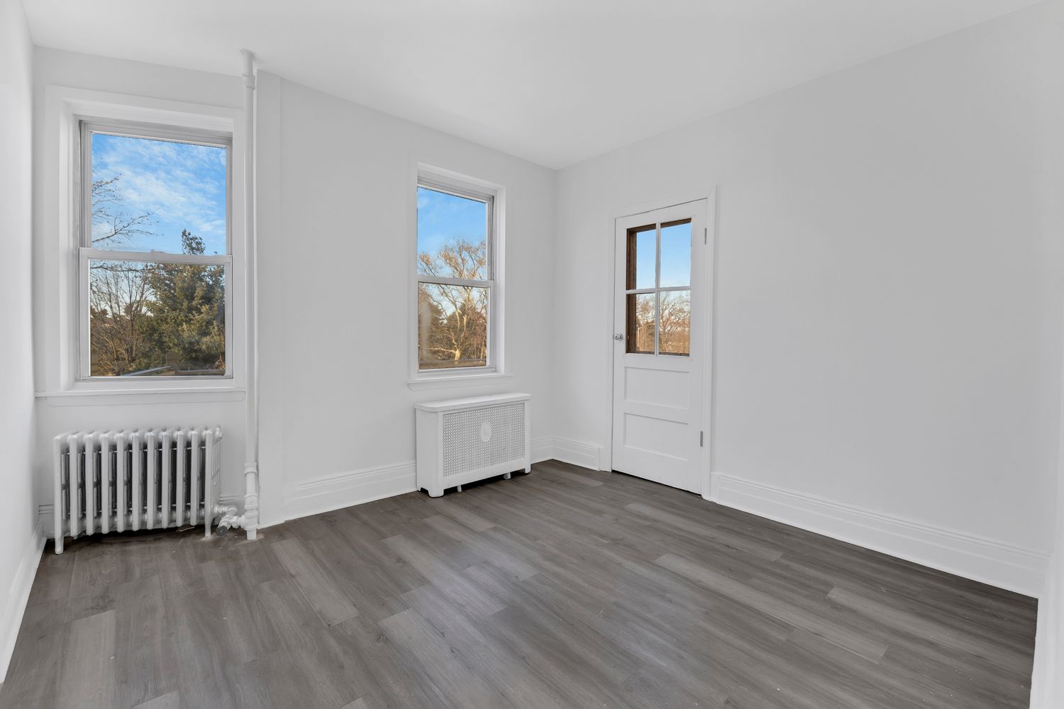 7001 Shore Road, Unit 2 Brooklyn, NY 11209 - Photo 8 of 17 a view of an empty room with wooden floor and a window