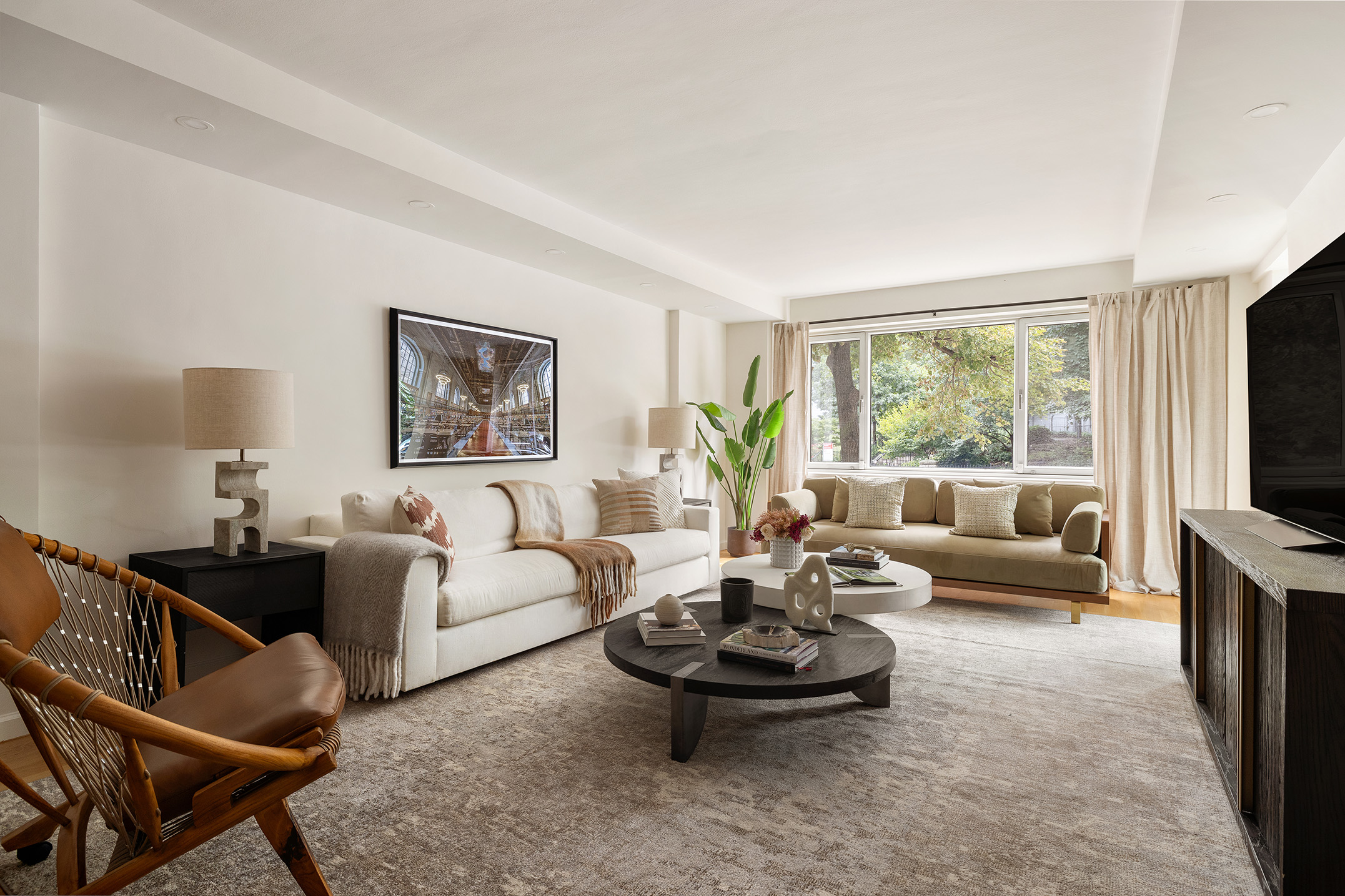 180 East End Avenue, Unit 1C Manhattan, NY 10128 - Photo 1 of 19 a living room with furniture and a flat screen tv