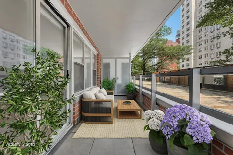 a living room filled with furniture and a potted plant
