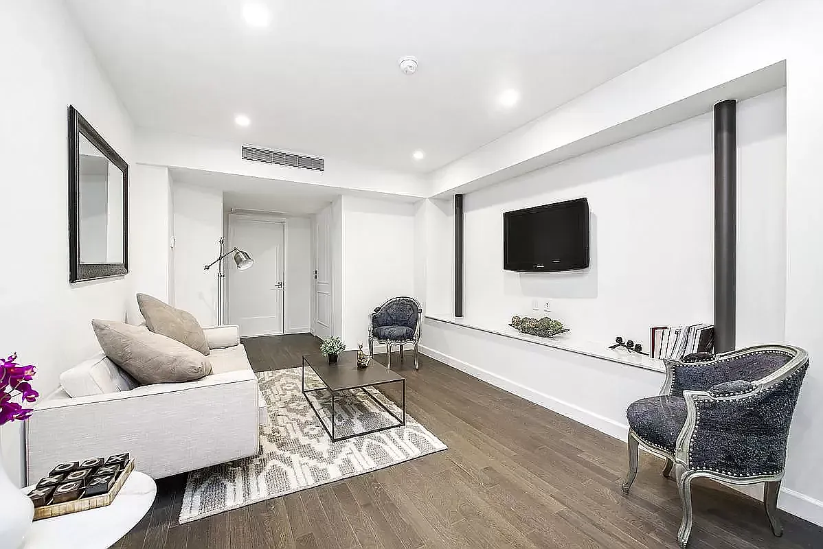 44 East End Avenue, Unit TH1 Manhattan, NY 10028 - Photo 4 of 14 a living room with furniture and a flat screen tv