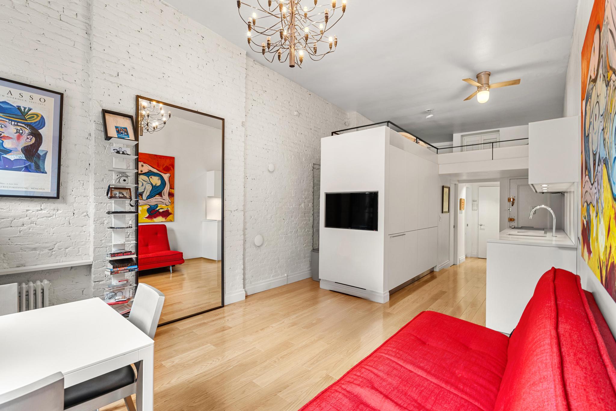 143 Sullivan Street, Unit 16 Manhattan, NY 10012 - Photo 9 of 10 a living room with furniture