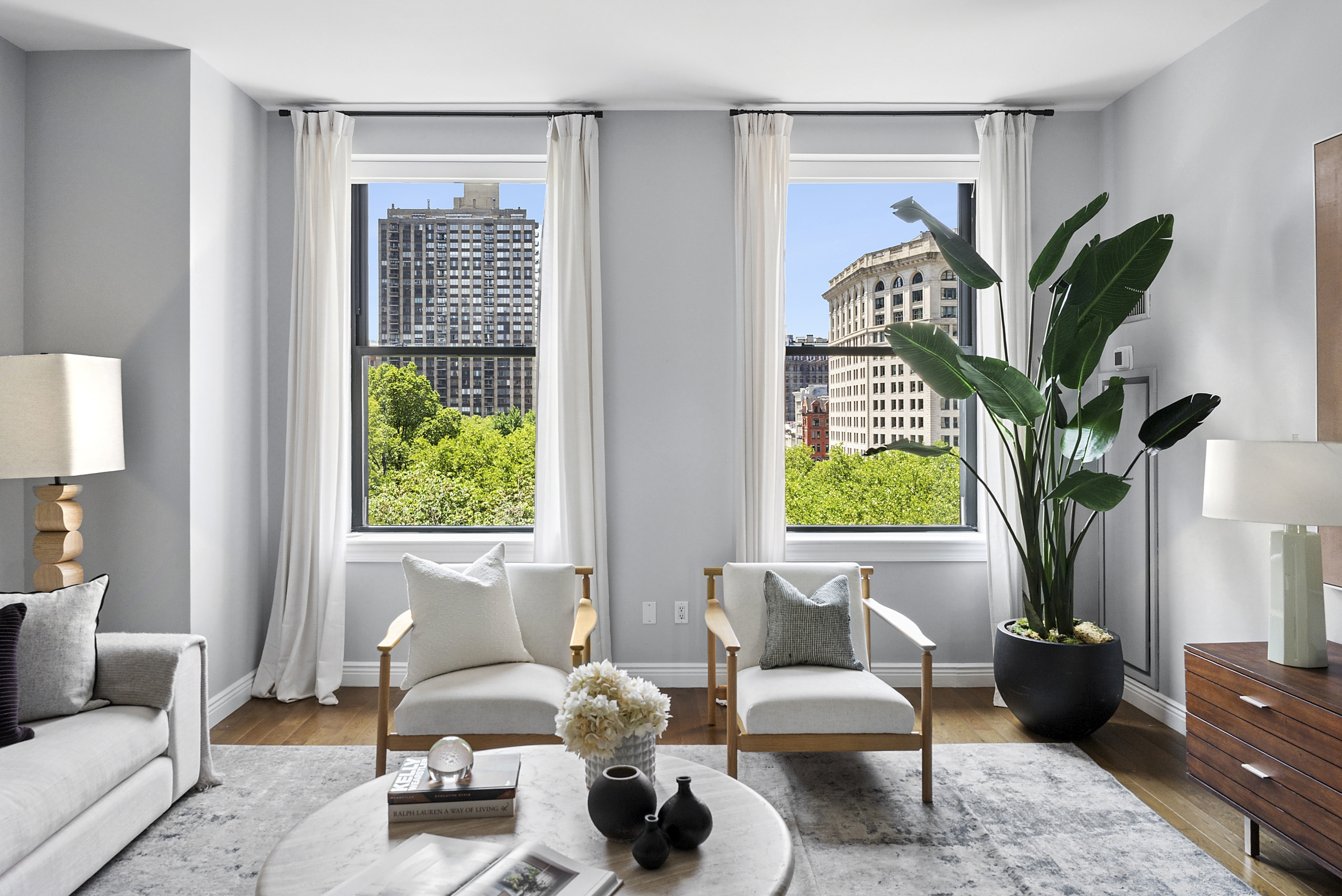 225 5th Avenue, Unit 7K Manhattan, NY 10010 - Photo 2 of 15 a living room with furniture and a large window