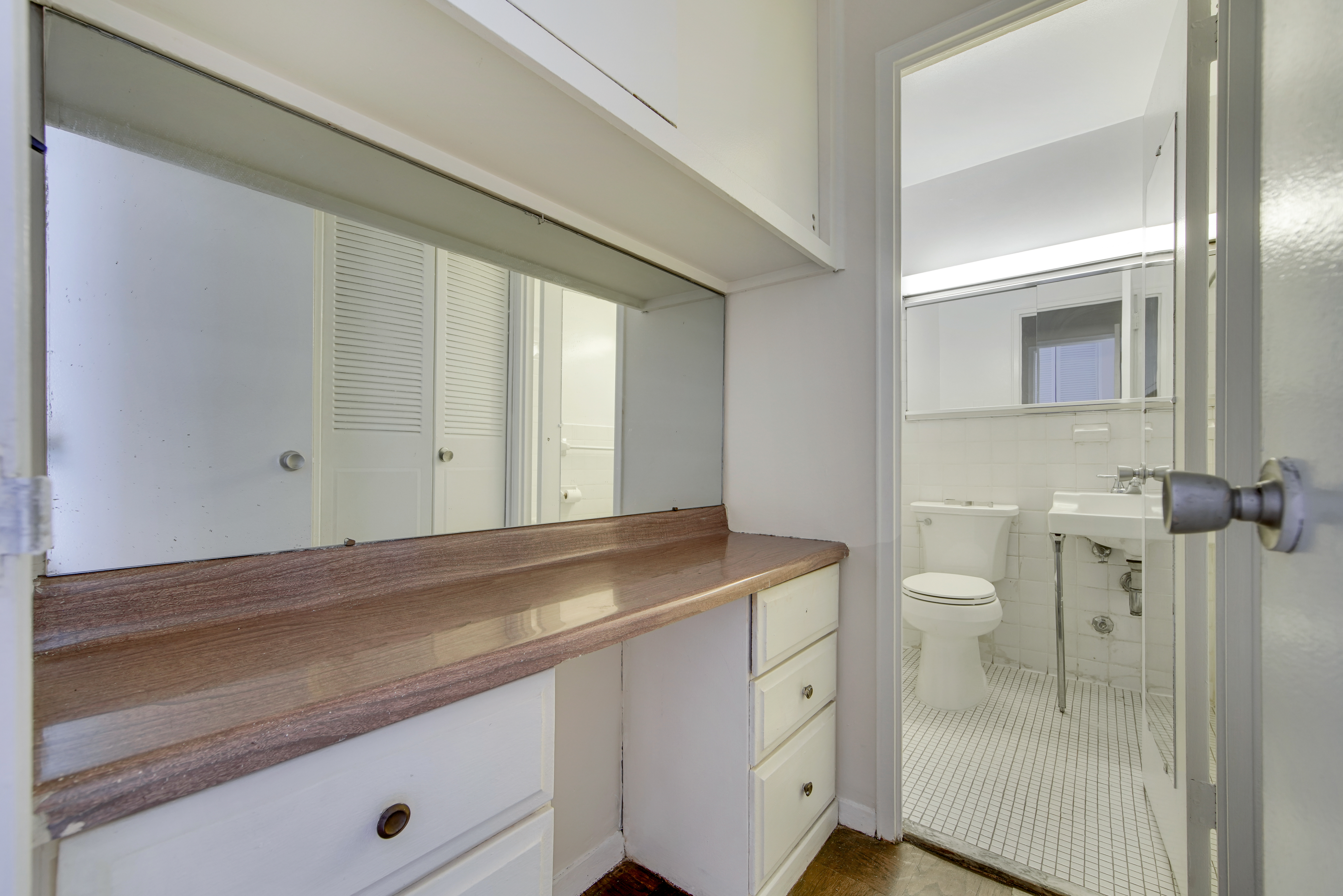 220 East 60th Street, Unit 3F Manhattan, NY 10022 - Photo 5 of 8 a bathroom with a sink a toilet and shower