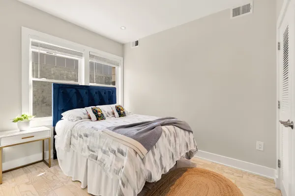 a bedroom with a bed and glass windows